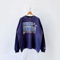 a sweatshirt hanging on a clothes rack with the words dalia cowboys printed on it