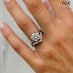 a woman's hand with a diamond ring on her left hand and an engagement band