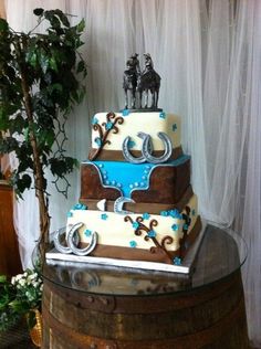 a three tiered cake sitting on top of a barrel