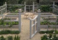 an outdoor vegetable garden with tables and chairs in the center, surrounded by graveled area