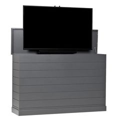 a flat screen tv sitting on top of a gray box