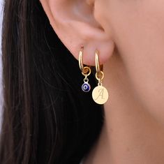 These small hoop earrings are a set of 2 mismatched huggie hoop earrings. The one earring has a evil eye charm on it while the other has a gold charm.  Any combination of hoop is available. Hoops - Gold plated surgical stainless steel Charms - gold plated sterling silver 925 Trendy Small Hoop Earrings With Charms, Charm Huggie Hoop Earrings For Gift, Charm Hoop Earrings As Gift, Hoop Earrings With Charms As Gift, Hoop Huggie Earrings With Dangling Charms For Gifts, Round Huggie Earrings With Charms As Gift, Round Huggie Earrings With Charms For Gifts, Hoop Earrings With Charm, Hoop Earring Set