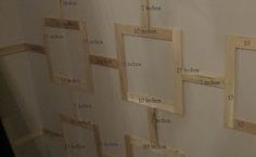 a bathroom wall with several pieces of wood taped to the wall and attached to the shower curtain