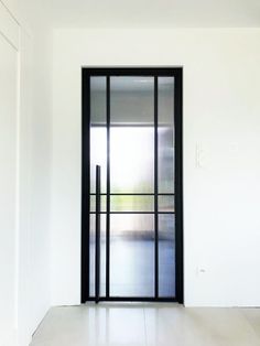 an empty room with sliding glass doors and white walls