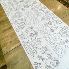 a large sheet of paper that has the words christmas on it and other holiday related items