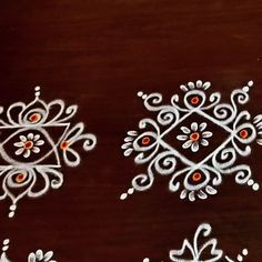 some white and red designs on a wooden surface