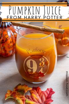 pumpkin juice from harry potter is in a glass with a cinnamon stick on the rim