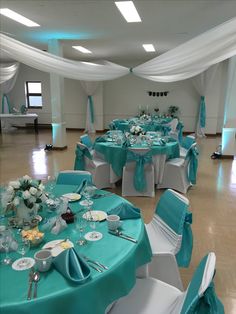 the tables are set up with blue and white linens