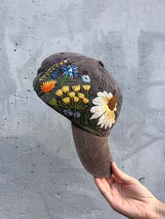 HAND EMBROIDERED WOMEN HAT WITH FLORAL DESIGN🌿PLEASE NOTE THIS HAT IS READY TO SHIP🌿Color: brown baseball cap;Design: hand-embroidered echinacea with wildflowers;Cap size (head circumference): 55 - 67 cm;Fabric: 100% cotton Twill, garment-washed.The quality of the embroidery and baseball hat is superior, I guarantee! ;)I really enjoyed making this, and I hope my customers will enjoy showing it off.GET 10% OFF YOUR 1ST ORDER!Get a 10% off coupon code for our Etsy shop by signing up to our maili Brimmed Hat With Floral Embroidery, Multicolor Embroidered Snapback Baseball Cap, Embroidered Flower Shaped Hat, Spring Baseball Cap With Floral Embroidery, Casual Embroidered One-size Hats, Floral Embroidery Baseball Cap For Summer, Embroidered Visor Hat, Brown Baseball Cap, Cotton Baseball Cap With Floral Embroidery