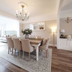 a dining room table with chairs and a chandelier