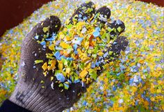 a person's hand is covered with confetti and sprinkles