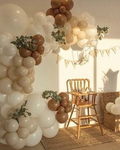 balloons and greenery are hanging from the ceiling