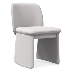 a white chair sitting on top of a white floor next to a gray countertop