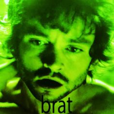 a man with long hair is making a face and has the words brat on it