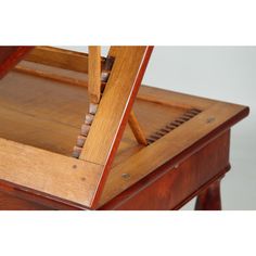 an old wooden table with some sort of weaving on it