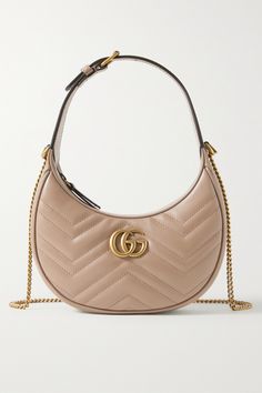 Gucci's saddle-shaped bag is the latest to join the label's iconic 'Marmont' family. Crafted in Italy from 'Porcelain Rose' leather, it has the signature quilted finish and gold 'GG' plaque at the front. The compact interior is fitted with a card slot so you can forego a wallet, while the chain strap can be completely removed for a more streamlined look. Circus Cookies, Gg Marmont Bag, Gucci Gg Marmont Mini, Handbags Gucci, Gg Marmont Mini, Dream Bags, Gucci Purse, Gucci Purses, Gucci Gg Marmont