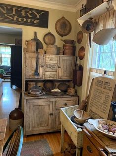 an old fashioned kitchen with lots of pots and pans