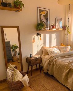 a bed sitting in a bedroom next to a window with plants on top of it