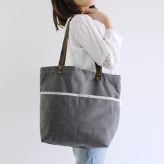 Handmade Canvas Tote Bag, Shoulder Bag With Leather Handle, School Bag Model Number: 14043 Dimensions: 15.7"L x 4.7"W x 17.7"H / 40cm(L) x 12cm(W) x 45cm(H) Weight: 3.09 lb / 1.4 kg Material: Waxed Canvas And Full Grain Leather Color: Gray Features: • Long Handle Drop • YKK Zipper • Cotton Lining • Inside zipper pocket, Laptop sleeve, Can fit 14" laptop, 1 cell pocket, 1 wallet pocket School Purse, Laptop Handbag, Grey Tote, Badass Style, Leather Duffle Bag, Purse Vintage, Bag School, Leather Duffle, Monogram Tote