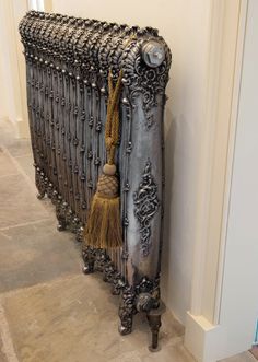 an old radiator with tassels on it is leaning against the wall