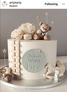 a white cake decorated with teddy bears and stars