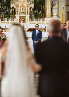 the bride and groom are standing at the alter