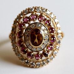 A magnificent harmony of citrine, garnets and diamonds, this is a ring of mythic proportions. 14k gold set with 0.70 carats of diamond. Available in sizes 5-8. Morgan Le Fay, Garnet And Diamond Ring, Replica Jewelry, Garnet Jewelry, Hand Made Jewelry, Gold Plated Earrings, Gold Set, Conflict Free Diamonds, Ring Set