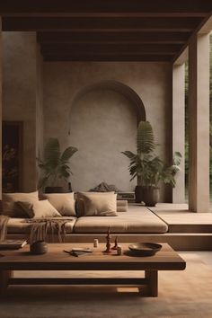 a living room filled with lots of furniture and plants