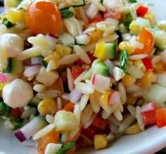 a white bowl filled with pasta salad on top of a table