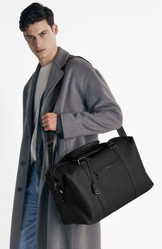 A lightweight all-leather companion overflowing with dynamic storage and multifaceted carriage for first class journeys. Inspired by thousands of miles transiting between airports, The Duffle features an expandable silhouette for enhanced visibility and effortless retrieval of your belongings, convertible trolley sleeve to carry atop luggage, dedicated phone, passport and laptop pockets, a detachable jacquard strap and slides perfectly into every overhead compartment. A thoughtful travel sidekic Luxury Black Travel Accessories For On-the-go, Modern Bags With Leather Trim For Business Trips, Black Leather Trim Travel Bag For Business, Modern Business Travel Bag With Leather Trim, Modern Travel Bag With Leather Trim For Business Trips, Modern Black Luggage With Removable Pouch, Black Leather Luggage With Leather Trim, Functional Duffle Bag For Business Trips With Leather Trim, Functional Travel Bag With Leather Trim For Business Trips