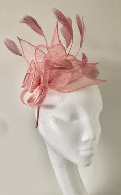 A gorgeous light pink/ blush coloured Fascinator crafted out of light Sinamay fabric. A striking full flower and leaf design, complemented by delicate feather detailing in the same shade makes this Fascinator hat a beautiful addition to any outfit. This piece sits firmly on the head with a co-ordinating satin coloured headband. This design can also be created on a comb please write this in the notes at checkout if you would prefer it on a comb. Headband measures 0.5cm wide. *All fascinators are light weight and comfortable to wear. *Handmade with love, packed and shipped in a sturdy box to ensure a safe delivery. *Looking for a customised fascinator or headpiece piece? Please feel free to send me a message! *If you'd like to send a phot of your outfit I can assist with colour matching/ adv Pink Kentucky Derby Fascinator For Wedding Guest, Pink Fascinator For Kentucky Derby Wedding Guest, Pink Feminine Fascinator For Royal Ascot, Pink Feminine Fascinator For Kentucky Derby, Pink Headpieces For Royal Ascot Event, Elegant Pink Headband For Kentucky Derby, Elegant Pink Headpiece For Royal Ascot, Elegant Pink Hair Accessories For Royal Ascot, Pink Fascinator For Races With Pinched Crown