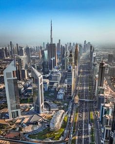 an aerial view of a city with skyscrapers and roads in the foreground, surrounded by other tall buildings