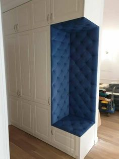 a blue and white storage unit in the corner of a room