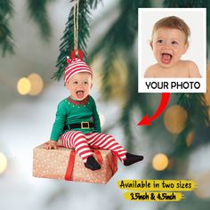 an ornament hanging from a christmas tree with a baby's photo on it