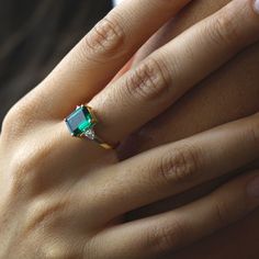 "Handmade by an inspired jewelry artist team with decades of experience in the craft of jewelry making. Each gemstone, each diamond is carefully picked. Using only the finest raw materials and the highest industry standard in manufacturing, design and finish. An elegant Emerald ring set with a 10x8 Green Chatham Emerald, 3.25 ctw and a pair of trillion cut Moissanites 3.5 mm excellent cut, Super clean VVS 0.33 ctw. The Moissanites are super sparkly, they look like flawless diamonds. All ring siz Emerald Gold Ring, Minimal Life, Natural Emerald Rings, Jewelry Artist, Zierlicher Ring, Art Deco Engagement, Deco Engagement Ring, Art Deco Engagement Ring, Inspired Jewelry