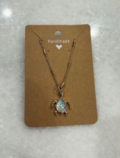 a necklace with a crab charm on it