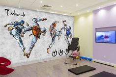 a room with a large wall mural depicting two men doing karate in front of a tv