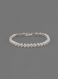 This enchanting white gold crystal tennis bracelet features hand-set Cubic Zirconia crystals. This medium weight bracelet can be worn alone or stacked for the ultimate glamour look Materials - Available in: 18K White Gold over Brass - Cubic Zirconia pave crystals - Hypoallergenic, lead, and nickel free Details - Available in 2 sizes: 6.5in (16.5cm) or 7in (17.8cm) - Width: 0.25in (6mm) - Fold over clasp ► SHOP SILVER BRIDAL BRACELET COLLECTION https://www.etsy.com/shop/AMYOBridal?section_id=2296 Dazzling Tennis Bracelet With Sparkling Stones For Wedding, White Sparkling Stones Tennis Bracelet For Wedding, Wedding Tennis Bracelet With Sparkling Stones, Wedding Tennis Bracelet With Sparkling Cubic Zirconia, Wedding Crystal Tennis Bracelet With Brilliant Cut, Wedding Crystal Tennis Bracelet Sparkling, Crystal Sparkling Tennis Bracelet For Wedding, Sparkling Crystal Tennis Bracelet For Weddings, Classic Silver Crystal Bracelet