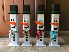 three snowmen made out of toilet paper tubes