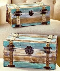 two wooden boxes with rope handles on the top and bottom, sitting on a chair