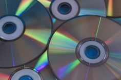 several cds with different colors and sizes on them