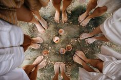 a group of people standing in a circle with their feet on each other's legs