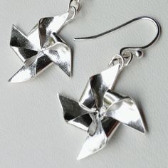 These fun and playful origami earrings are modeled after paper pinwheels, which dangle and sparkle.  Each is folded from a single square sheet of .999 fine silver, kiln fired, and polished to a high shine.  Pinwheels alone are just under an inch across, and weighs about 1.5 grams. The ear wires are sterling silver. Comes in a tissue lined jewelry box, perfect for gifting.  Ready made, and can usually ship out within one business day. Origami Pinwheel, Pinwheels Paper, Origami Jewelry, Silver Jewelry Handmade, Fine Silver, Jewelry Inspiration, Etsy Listing, Jewelry Earrings Dangle, Origami