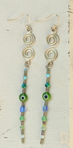 🧿Long Swirly Green Evil Eye Dangle Earrings🧿 These earrings are silver swirls paired with a green evil eye and various green toned beads! Earring hook is nickel free!  All earrings can be modified to a closable hook clasp for my peeps with gauges! ✌🏻Thanks for visiting Cam's Hippie Hut✌🏻 Green Evil Eye, Gold Bead Earrings, Abalone Earrings, Gold Starburst, Starburst Earrings, Harrisburg Pa, Rose Gold Beads, Evil Eye Earrings, Earring Hook