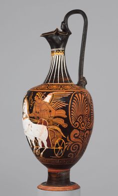 an antique vase with horses and chariots painted on the side, sitting on a pedestal