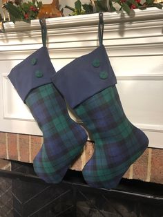 two christmas stockings hanging from a fireplace mantel