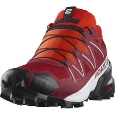 a red shoe with black laces on the side and white lettering that says salmo