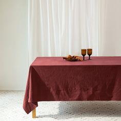 a red table cloth with two glasses on it