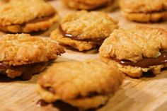 cookies with chocolate on top are sitting on a cutting board and ready to be eaten