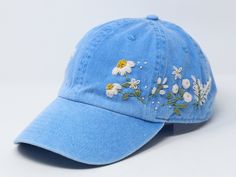 Flower is 100% hand embroidered on a 100% cotton wash baseball cap. Hat is one size fits all with adjustable back strap. Unique cap, one of a kind! I am also open for customization. If you want the item in different colors, please message me, it will take additional 2-3 days of handling time. Free first class shipping, upgradable priority mail service. 30 days return policy, feel confident at your purchase! Cheap Embroidered Cap, Affordable Embroidered Baseball Cap, Embroidered Blue Spring Hats, Spring Embroidered Blue Hats, Blue Embroidered Spring Hats, Blue Embroidered Baseball Cap For Summer, Blue Hats With Embroidered Logo For Spring, Blue Embroidered Visor Baseball Cap, Embroidered Blue Dad Hat Adjustable